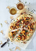 Pizza with chanterelle mushrooms, gorgonzola and cashew nuts