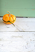 A pumpkin on a wooden surface