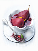 Plums baked in red wine with cinnamon