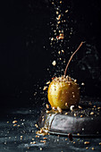 Apple with caramel and crushed nuts