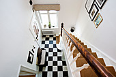 Carpeted staircase and chequered floor
