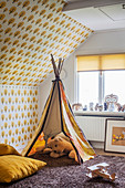 Play wigwam and retro wallpaper in child's bedroom with ochre colour scheme