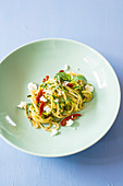 Courgette noodles with dried tomatoes, feta cheese and mint