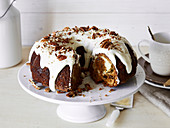 Carrot cheesecake Bundt cake with cream cheese frosting and pecan nuts