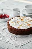 Chocolate, almond and cherry cake with a meringue topping