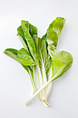 Bok choy on a white surface