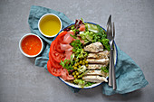 Healthy salad with chicken, green peas and tomatoes