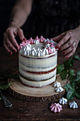 Cranberry vanilla layer cake with a meringue wreath
