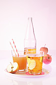 An arrangement of fruit juices (apple juice, and pear and orange juice)