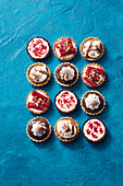 Toblerone mousse tarts; orange ricotta tarts with candied rhubarb; wagon wheel tarts; cheat s raseberry ripple cheesecake tarts