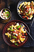 Chicken and aubergine stew with tomatoes, rigatoni and ricotta