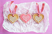 Three heart-shaped biscuits on a piece of paper