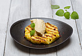 Grilled pineapple with pink pepper, vanilla ice cream and lemon balm