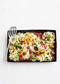 Chicken with herb pasta on a baking tray