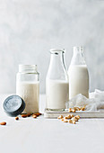 Almond milk, macadamia nut milk and cashew nut milk in bottles