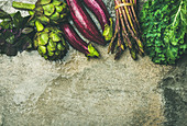 Green and purple fresh vegetables: Eggplans, beans, kale, asparagus, artichoke, basil