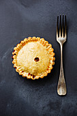 Homemade Pie and fork on blackboard background