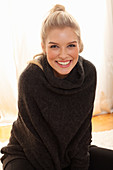 A young blonde woman wearing a dark jumper