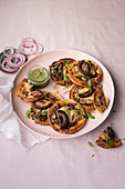 Puff pastry tartlets with red onions and mushrooms