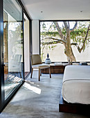 Modern bedroom with panoramic windows and balcony