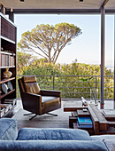 Masculine leather armchair in living room with panoramic window