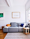 Gray sofa in the simple living room with coffered ceiling