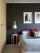 Black wall and fitted wardrobes in modern bedroom