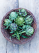 Green artichokes in a wicker basket