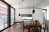 Dining area with antique dining table and chairs, custom-made worktop and hatch