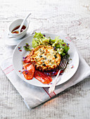 A mini vegetable quiche with a side salad