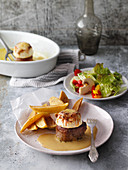 Pork fillet with apple halves, curry sauce, chips and a summer salad