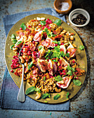 Pilaf with bacon, figs and pomegranate seeds