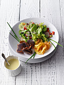 Mixed leaf salad with colourful potato crisps and potato dressing