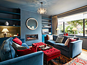 British-style living room in blue and red with fitted shelves