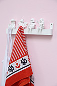 Coat pegs made from white-painted toys