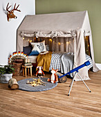 Fabric house over the bed in the children's room with a natural theme