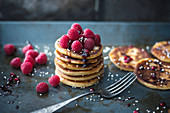 Vegan pancakes with chocolate sauce, raspberries and popped amaranth