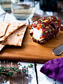 Date dotted goat cheese log on cheese board