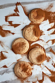 Snickerdoodle cookies on a white marble table with cinnamon