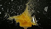 Glass of juice exploding, slow motion