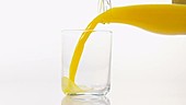 Orange juice in glass, slow motion