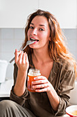 Woman eating honey