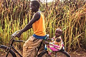 Boy and baby riding a bicycle