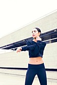 Woman in sports clothes stretching