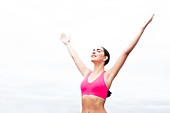 Woman wearing sports bra with arms up