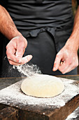 Yeast dough being dusted with flour