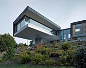 Modern architect-designed house with storey projecting over slope