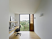 Purist study with panoramic view through floor-to-ceiling window
