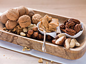 A selection of nuts and a spoonful of peanut butter