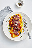 Saddle of lamb in a herb coating with mashed sweet potatoes